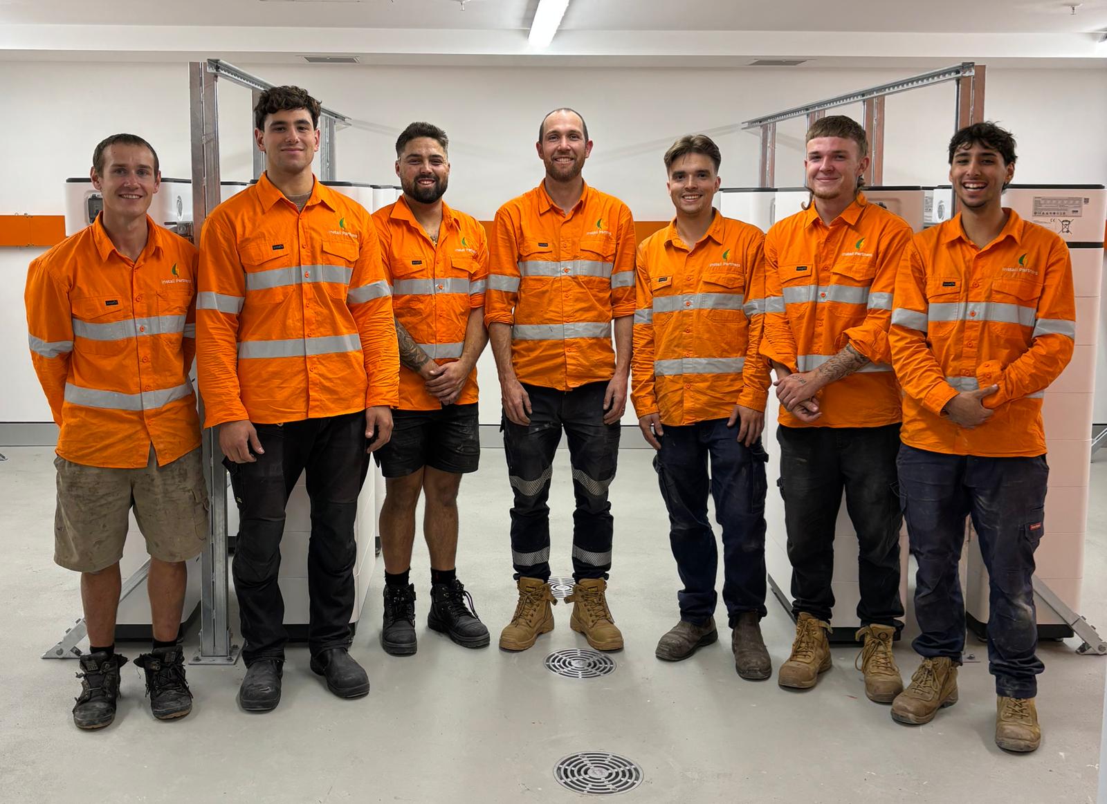 Install Partners Australia team in orange hi-vis workwear