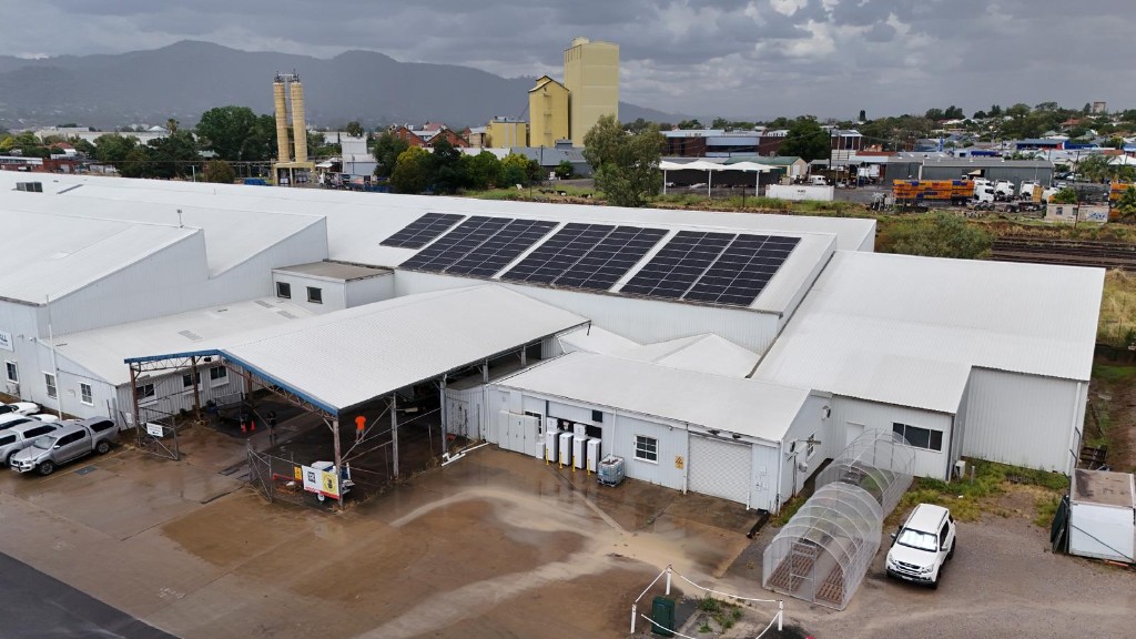 Aerial view of commercial warehouse with rooftop solar arrays